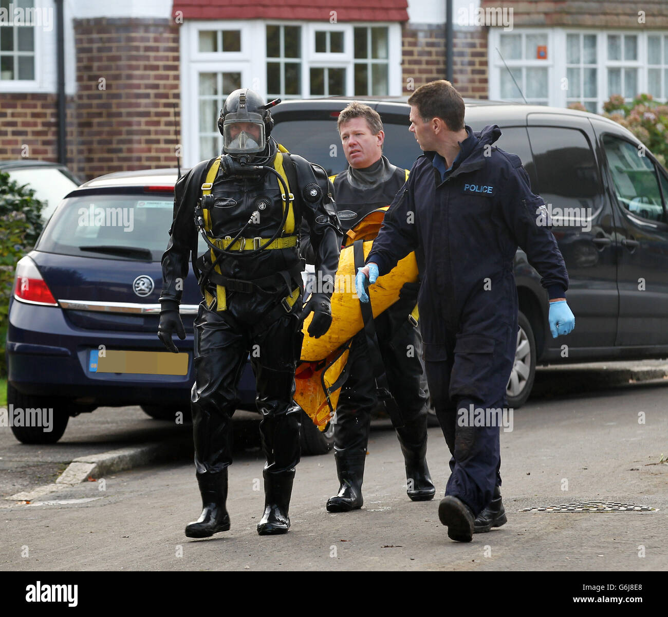 Officers from the Underwater and Confined Space Search Team during the recovery operation of a body that was discovered in the well of a property on Audley Drive, Warlingham, Surrey. Stock Photo