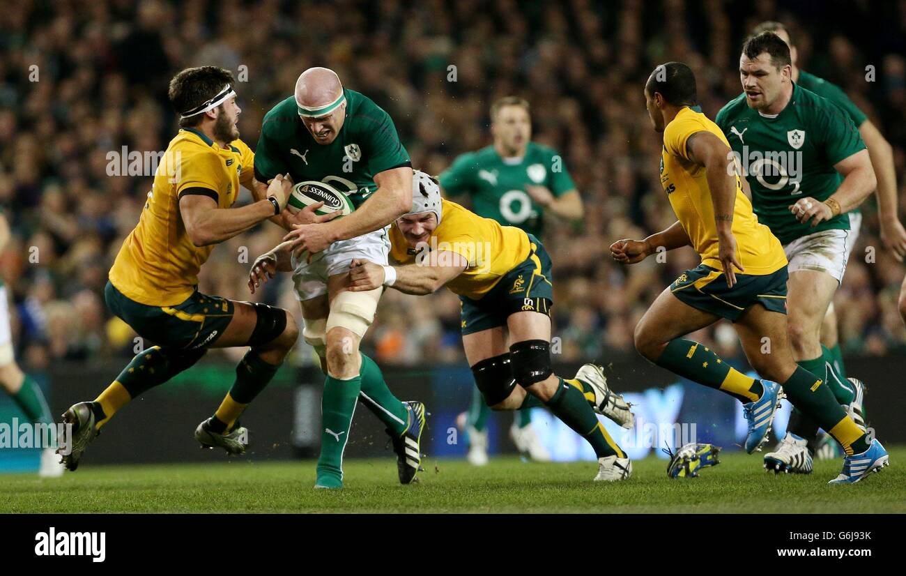 Ireland's Paul O'Connell is tackled by Australia's Rob Simmons (left) and Ben Mowen (right) during the Guinness Series match at the Aviva Stadium, Dublin, Ireland. Stock Photo