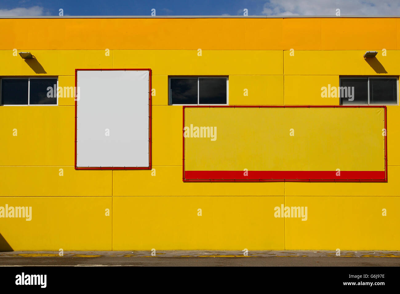 Blank billboard in a yellow wall, for advertisement Stock Photo