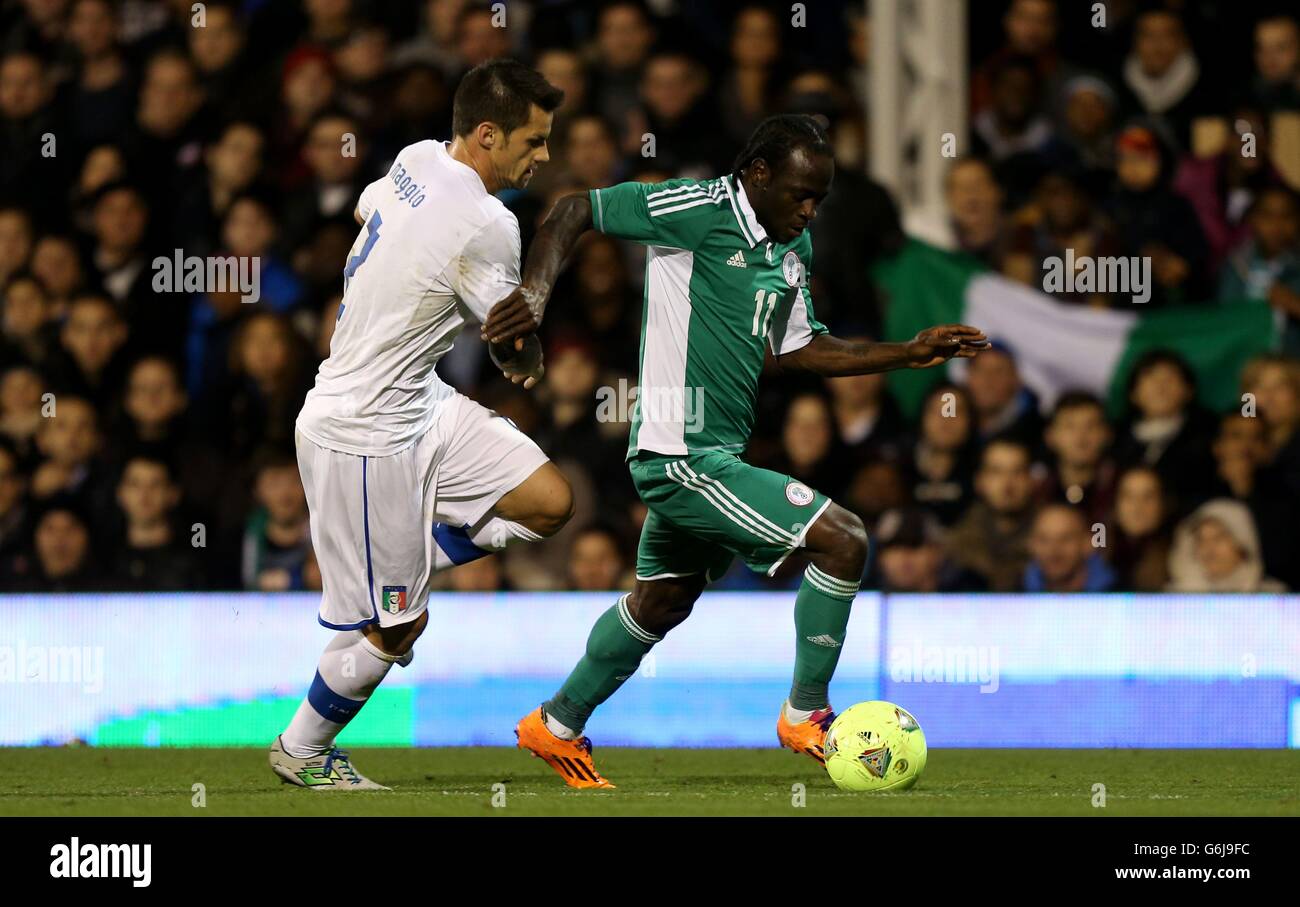 Italy's Christian Maggio holds back Nigeria's Victor Moses (right) during the International Friendly at Craven Cottage, London. Stock Photo