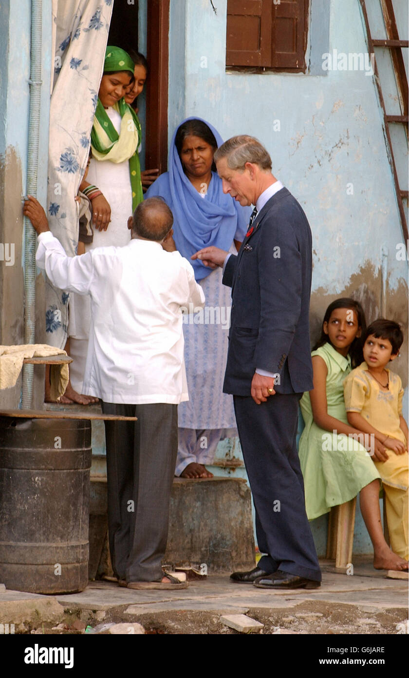 The Prince of Wales talks with Mr Jockin Arputham (left), the President of the National slum Dwellers Federation, in the Dharavi slum area on the outskirts of the city of Bombay, India. * Charles, who yesterday enjoyed the bright lights of the Bollywood film world, was making the journey to see the city's vast make-shift dwellings. Stock Photo