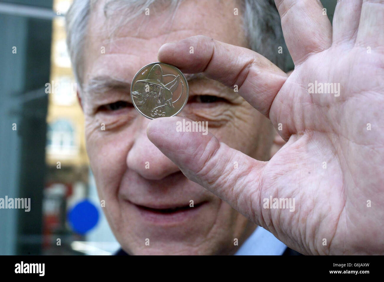 Sir Ian McKellen, who plays Gandalf in the Lord of The Rings Trilogy, unveils the new Royal Mint coin at the Odeon Leicester Square in London. The Royal Mint in conjunction with official licensee, New Zealand Post launches the first of the New Zealand The Lord of The Rings collector coins. Stock Photo