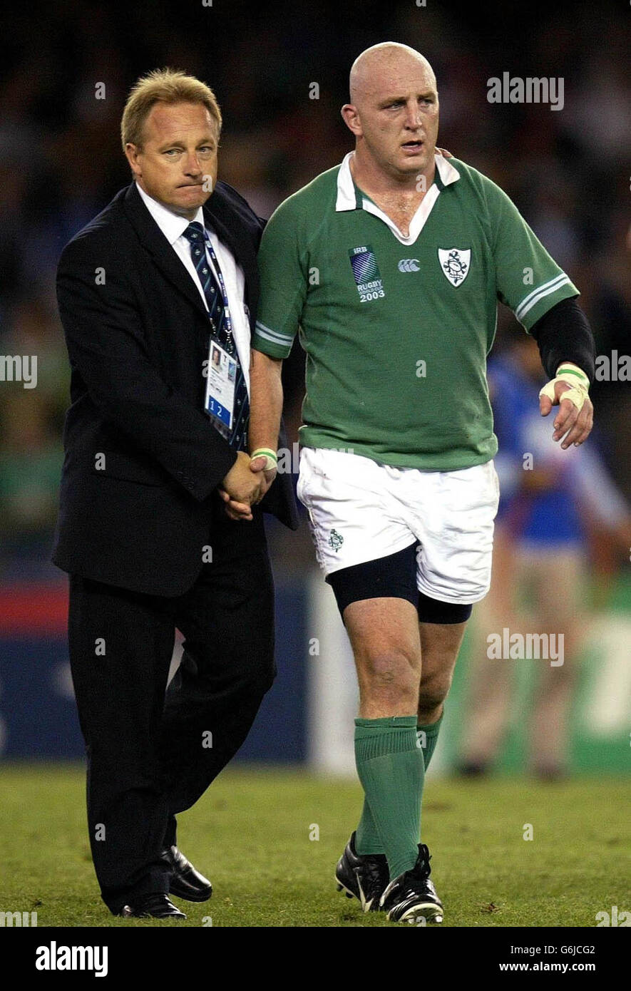 Keith Wood is consoled by coach Eddie O'Sullivan after thier 43-21 defeat by France in the the Rugby World Cup Quarter-Final match at the Telstra Dome, Melbourne, Australia. No mobile phone use, Internet sites may only use one image every five minutes during match: Stock Photo