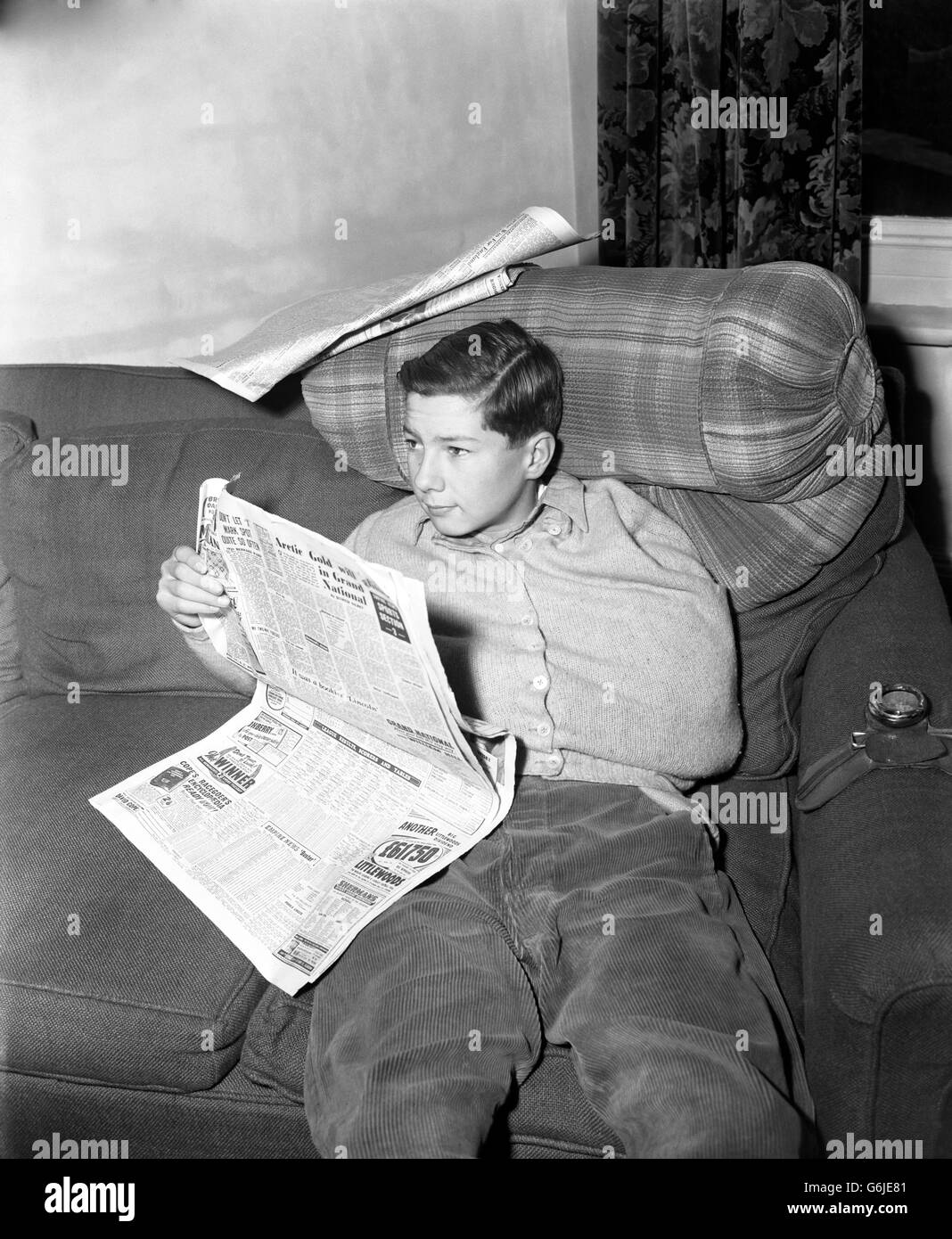 Seeing his accidents as others saw it is 15-year-old jockey LESTER PIGGOTT, pictured at home in Lambourn, Berkshire, as he reads an account of the mishap at Lincoln Races yesterday in which his collar bone was broken and his hopes for the Lincolnshire Handicap shattered. Piggott was thrown when his mount, Pandite, fell about 50 yards from the post when lying third in the first race. Second Out, his mount in the Lincolnshire - run an hour and a quarter later - had to be ridden by another jockey. Piggott is expected to resume riding in a fortnight. Stock Photo