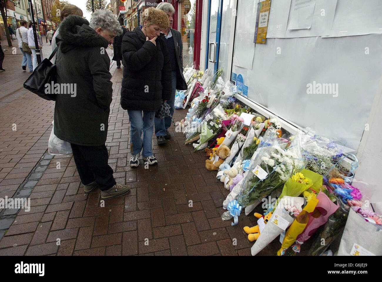 Flowers left at the Greggs Bakery in Carlisle, for a 10-month-old boy who was in the bakery with his mother Lorna, 20, when he was stabbed in the neck yesterday. The father of the boy was continuing to be questioned by police today. Locals named the 10-month-old victim as Hassan Martin. Men in the shop overpowered his attacker and officers from the city s central police station around 100 yards away were quickly on the scene. The baby was taken to Cumberland Infirmary where he was pronounced dead. His mother suffered injuries to her wrist but they were not thought to be life-threatening and Stock Photo