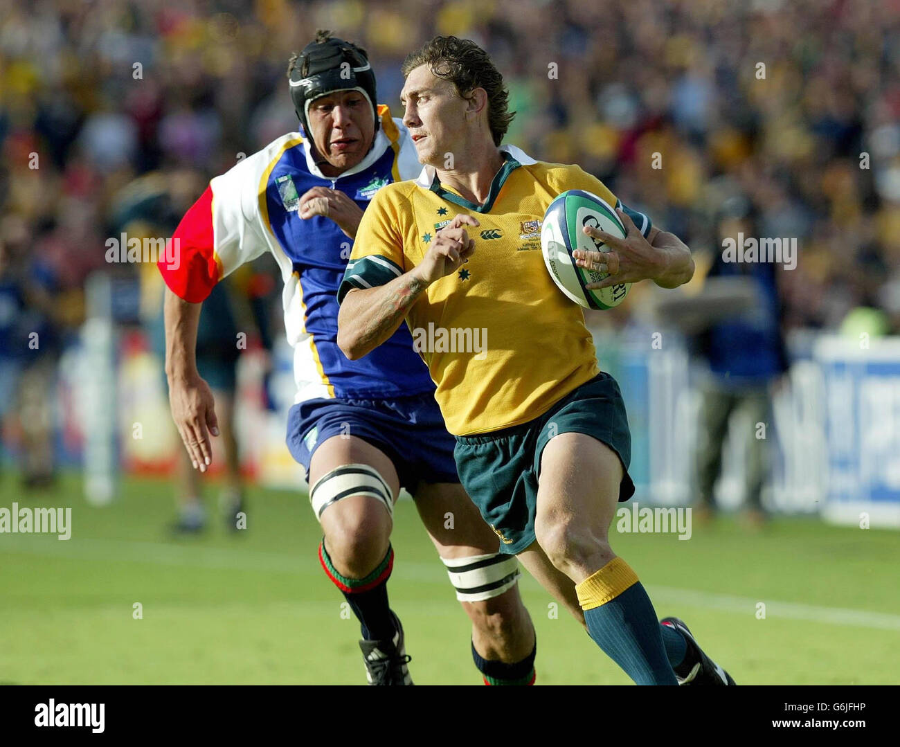 Matt Rogers beats the cover of Namibia's Jurgens van Lill to score Australia's 21st try in thier 142-0 victory in the Rugby World Cup Pool A match at the Oval Stadium, Adelaide. Stock Photo
