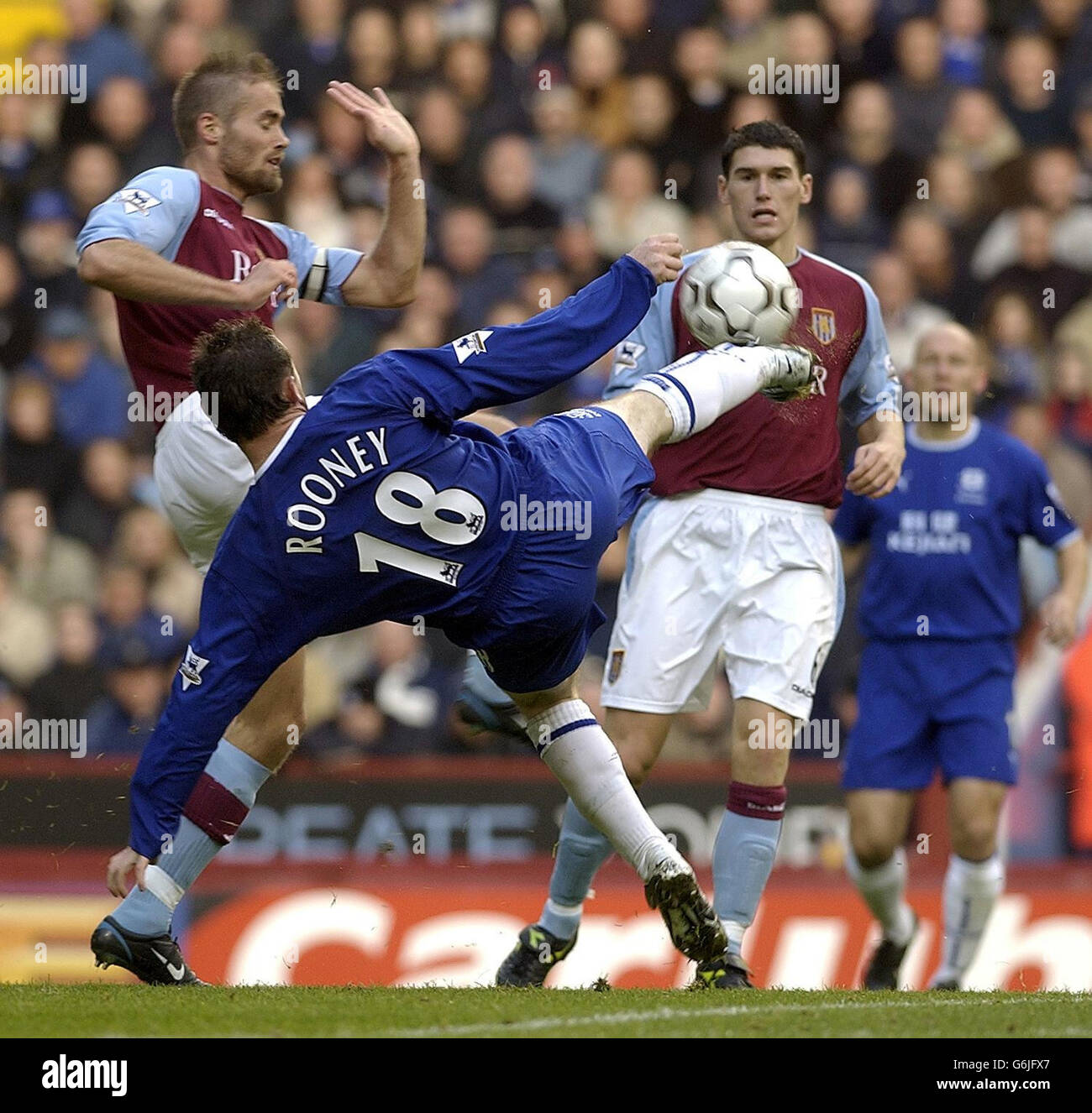 Aston Villa's Olof Mellberg (L) challenges Everton's Wayne Rooney during their Barclaycard Premiership match at Villa Park, Birmingham. Stock Photo