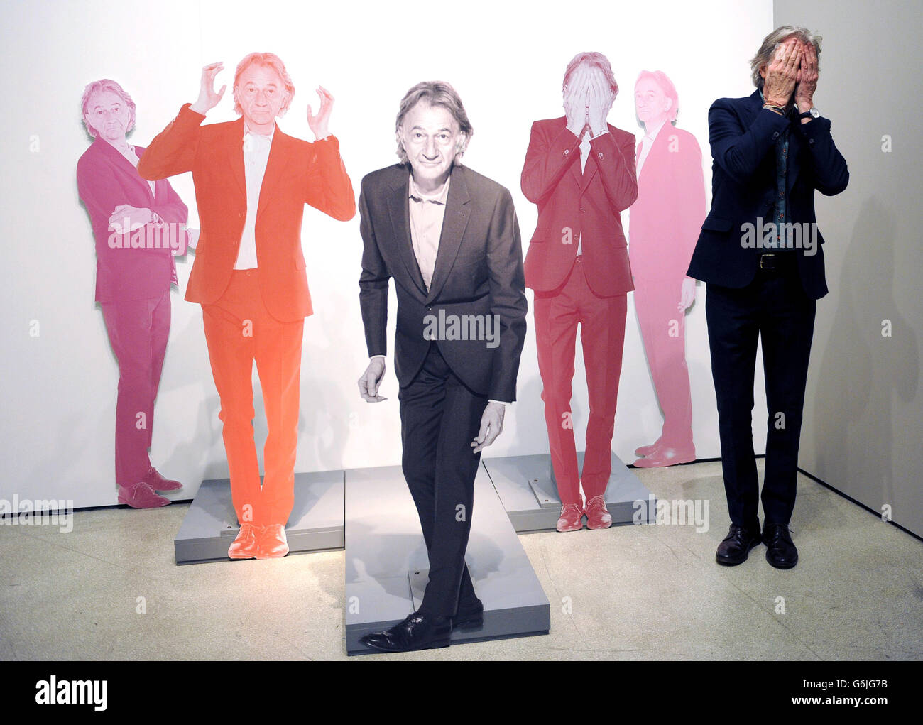 Fashion Designer Paul Smith poses for photographs at the opening of his new exhibition 'Hello, My Name is Paul Smith' at the Design Museum, London. The exhibition features hundreds of objects from the designers personal archive, including photographs, objects and many of his clothing designs from throughout his career. Stock Photo