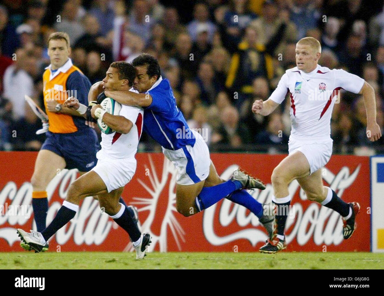 England's Jason Robinson is tackled by Brian Lima of Samoa as Iain Balshaw looks on during their 35-22 victory in their Rugby World Cup Pool match at the Telstra Dome in Melbourne, Australia. NO MOBILE PHONE USE. INTERNET SITES MAY ONLY USE ONE IMAGE EVERY FIVE MINUTES DURING THE MATCH Stock Photo