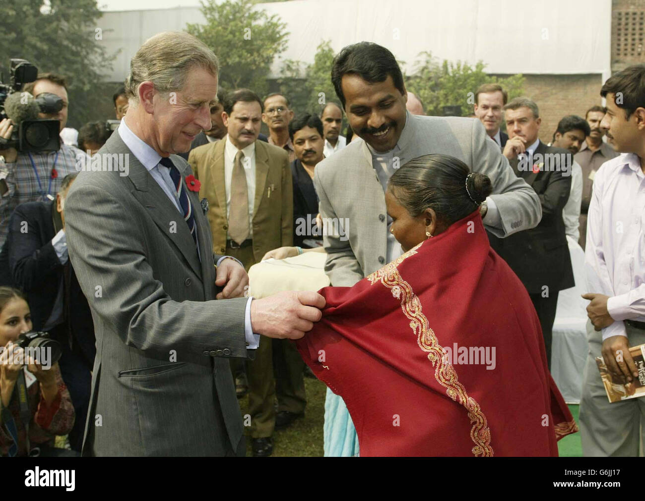 The Prince of Wales (left) meets Lali Bal (centre), who from the age of 12 was has worked as an untouchable who performs the degrading tasks of cleaning human waste from the homes of richer villagers, in Delhi, during his official visit to India. From the age of 12, Lali was forced to work from 5am until 11pm at night, carrying the excrement in a basket on her head for two kilometres to dispose of it. Stock Photo