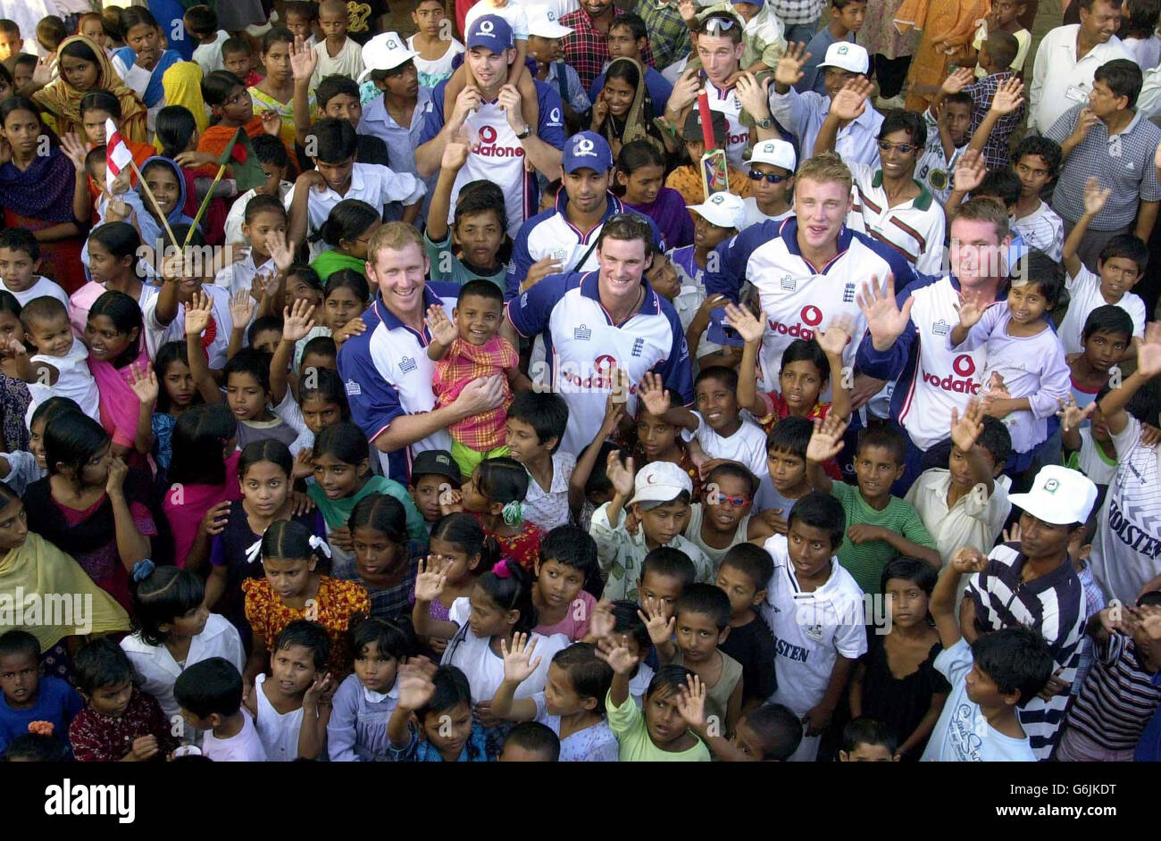 England one day international players (from left to right) Anthony McGrath, James Anderson (top), Vikram Solanki, Andrew Strauss, James Kirtley (top), Andrew Flintoff and Ian Blackwell are surrounded by local children from Sreepur Village in Bangladesh. The players who have arrived for the one-day international series against Bangladesh visit the village for 500 abandoned children and over 100 destitute women. Stock Photo