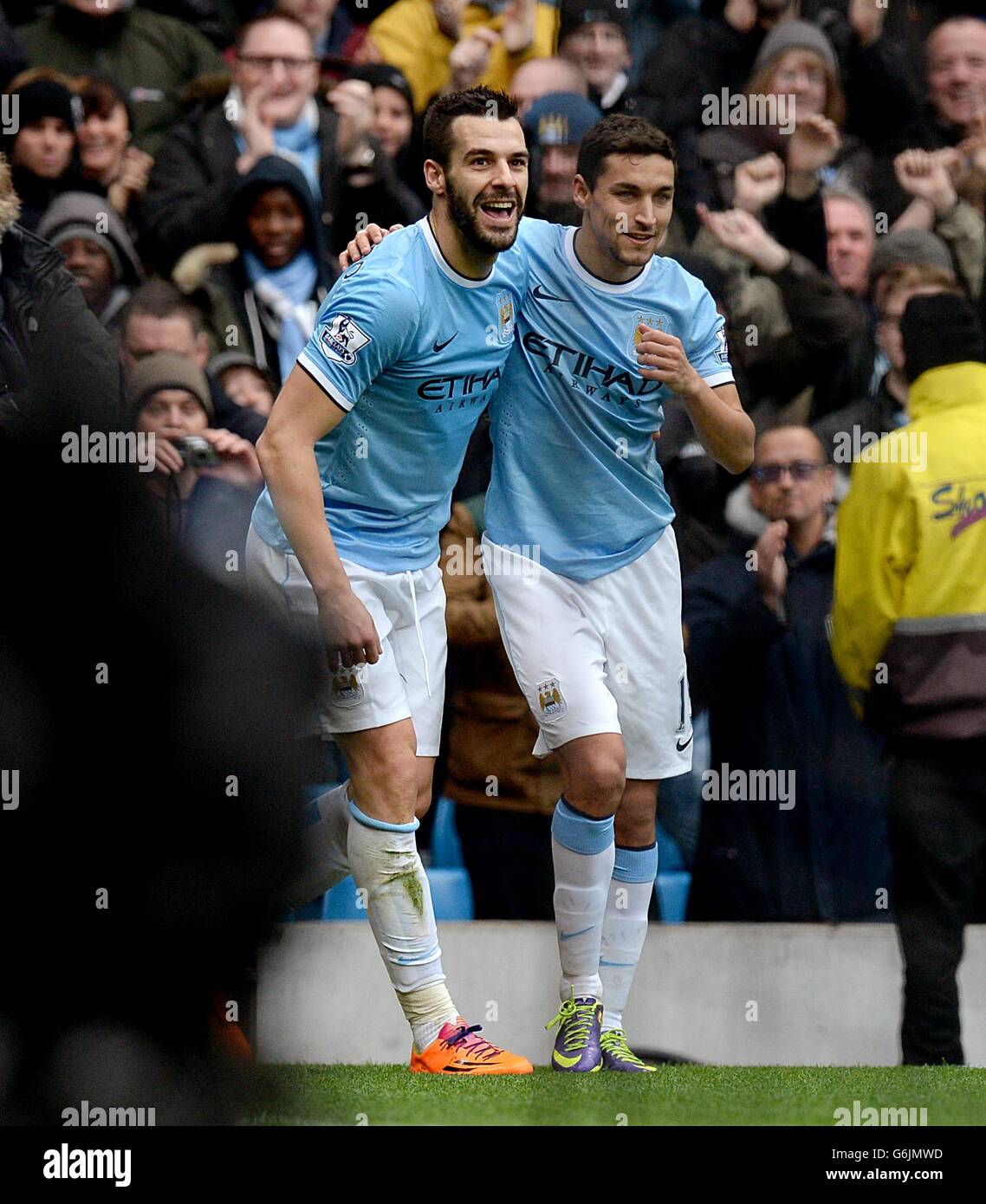 Manchester City's Alvaro Negredo (left) celebrates with team-mate Gonzalez Jesus Navas after his shot is turned in by Tottenham Hotspur's Raniere Sandro giving them their second goal of the game Stock Photo