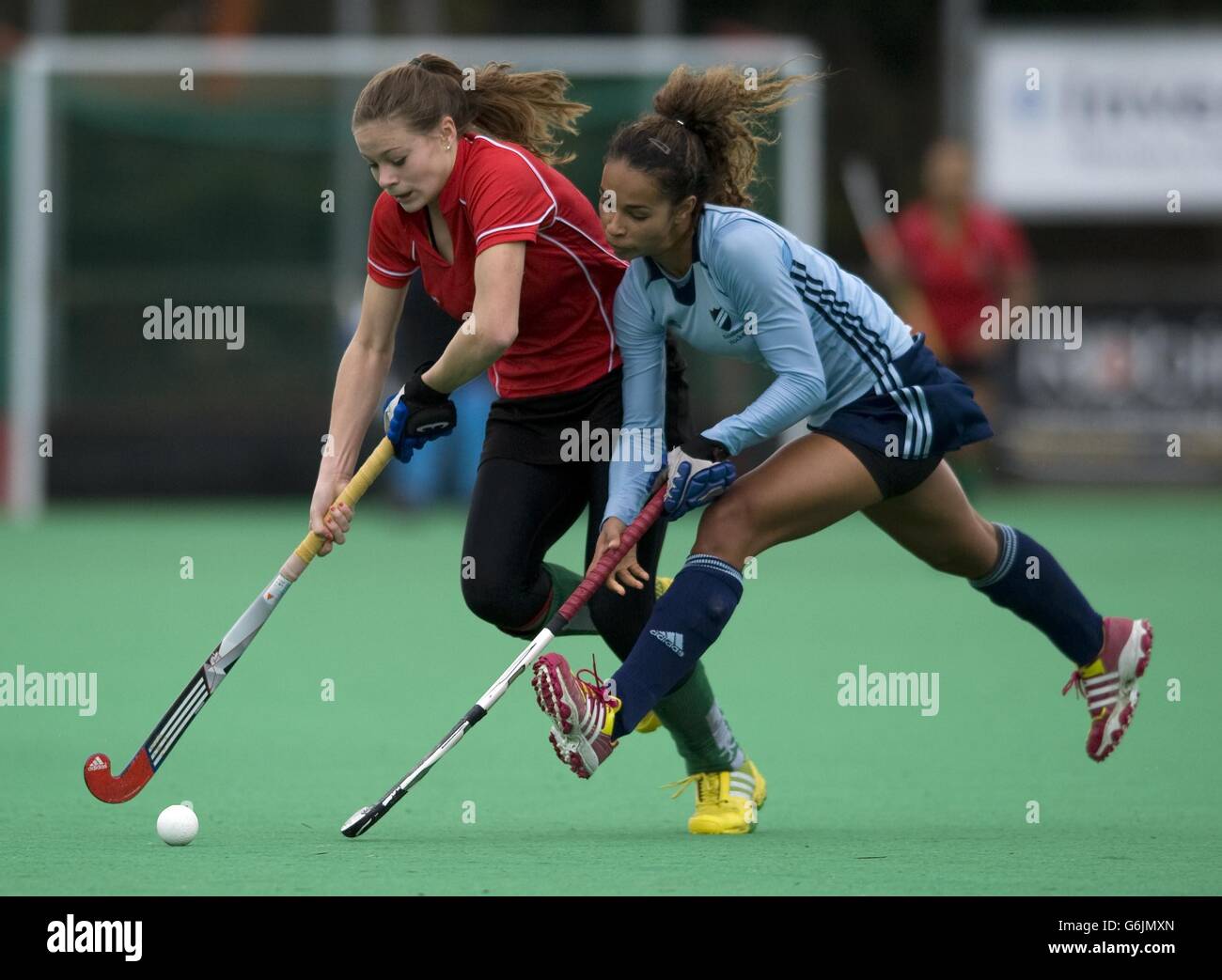 Canterbury's Eliza Brett is challeneged by Reading's Abi Harper during the Investec Women's Hockey League Premier Division game at Canterbury HC. Stock Photo