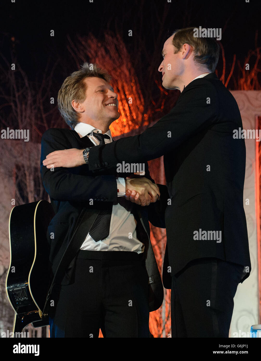 The Duke of Cambridge (right) shakes hands with Jon Bon Jovi after singing with him and Taylor Swift (not pictured) at the Centrepoint Gala Dinner at Kensington Palace, London. Stock Photo