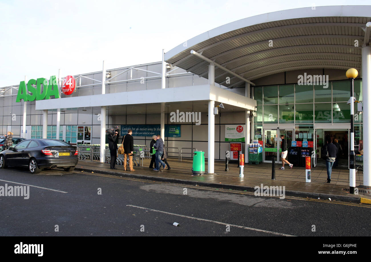 Shoppers leave the Westwood Asda store, in west Belfast where a woman