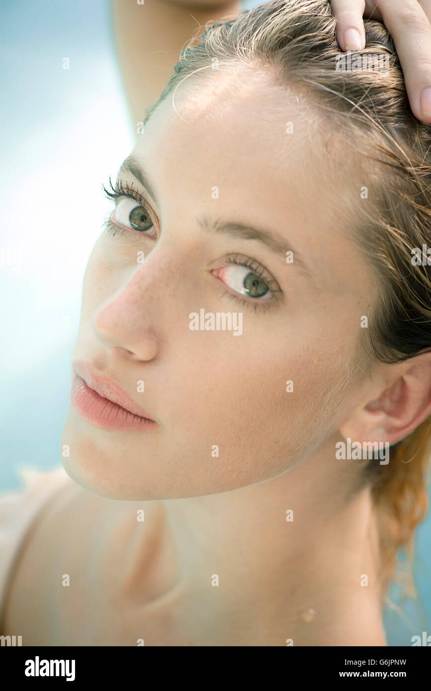 Woman with hand on head, portrait Stock Photo