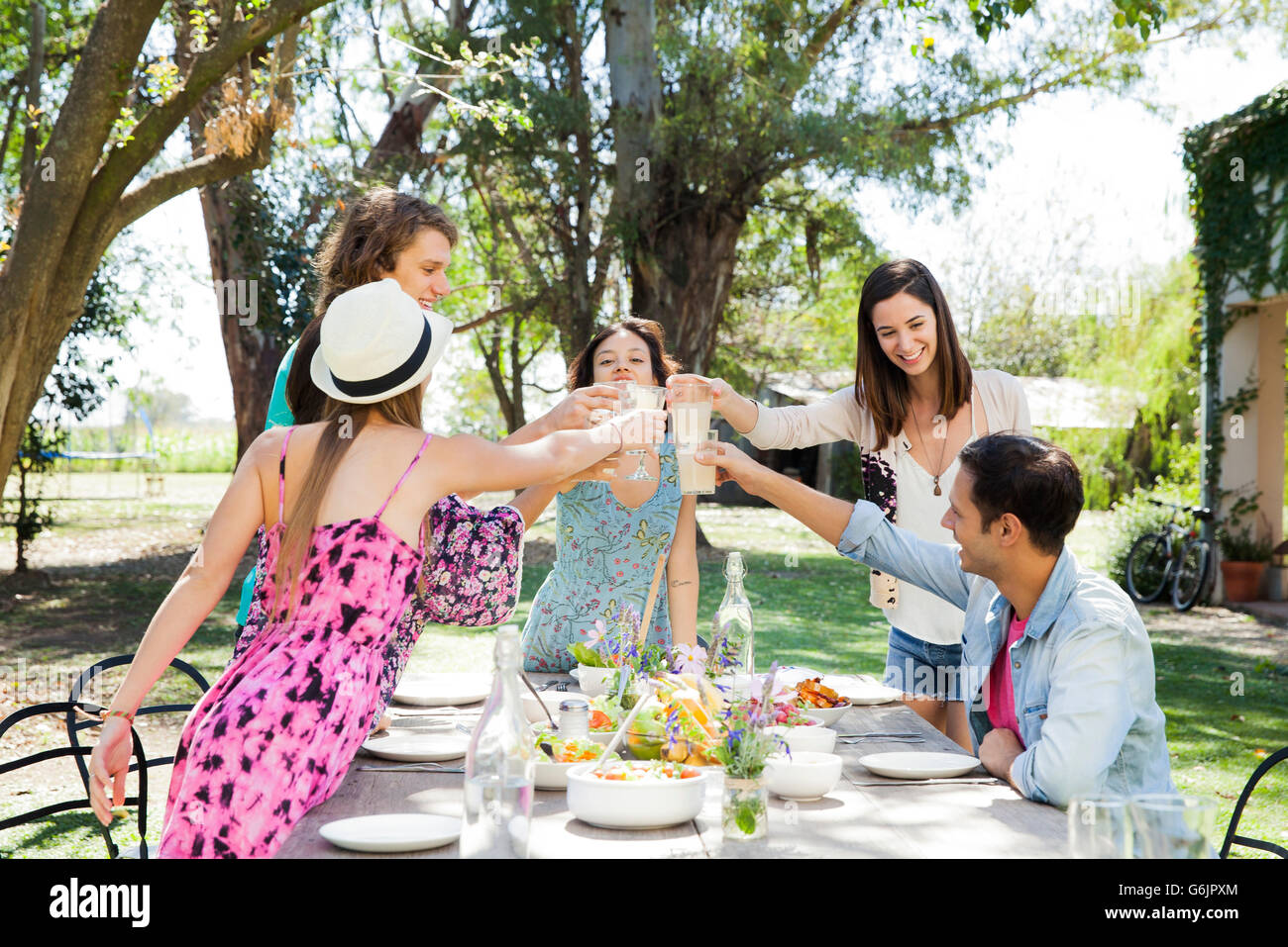 Friends celebrating together with meal outdoors Stock Photo