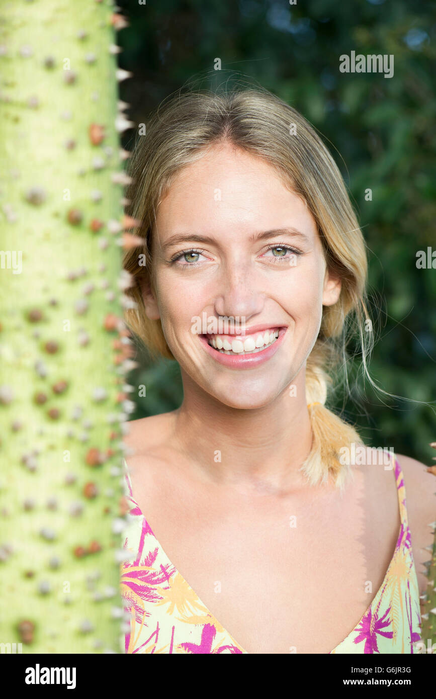 Young woman smiling cheerfully outdoors, portrait Stock Photo