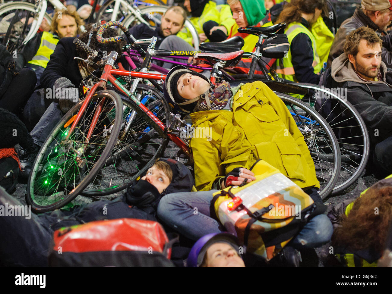 Cyclists take part in a 'die-in' protest outside the headquarters of Transport for London, in Blackfriars, London, calling for action to improve road safety for cyclists. Stock Photo