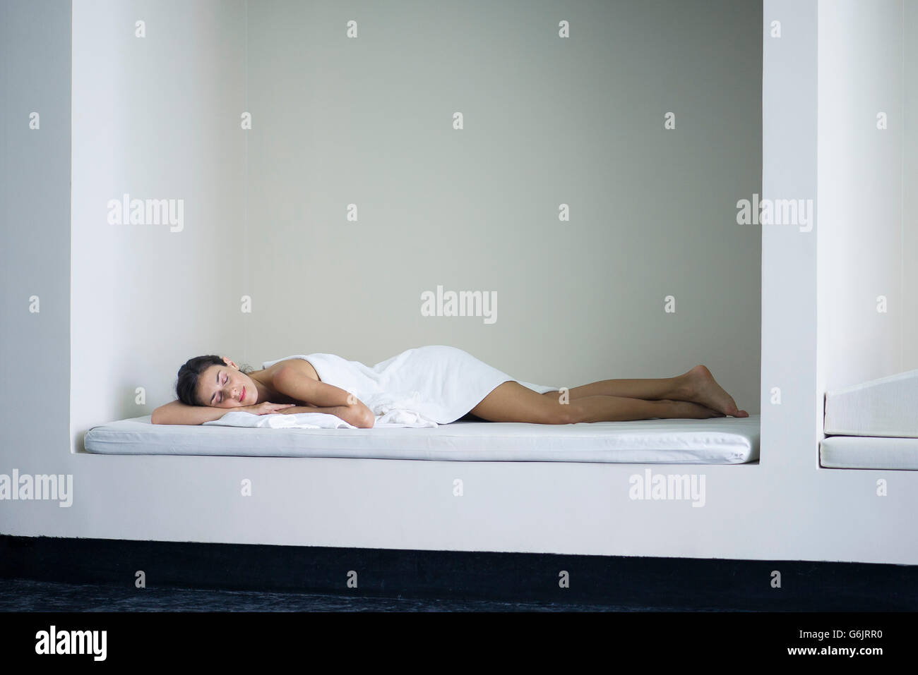Woman lying down in sauna Stock Photo
