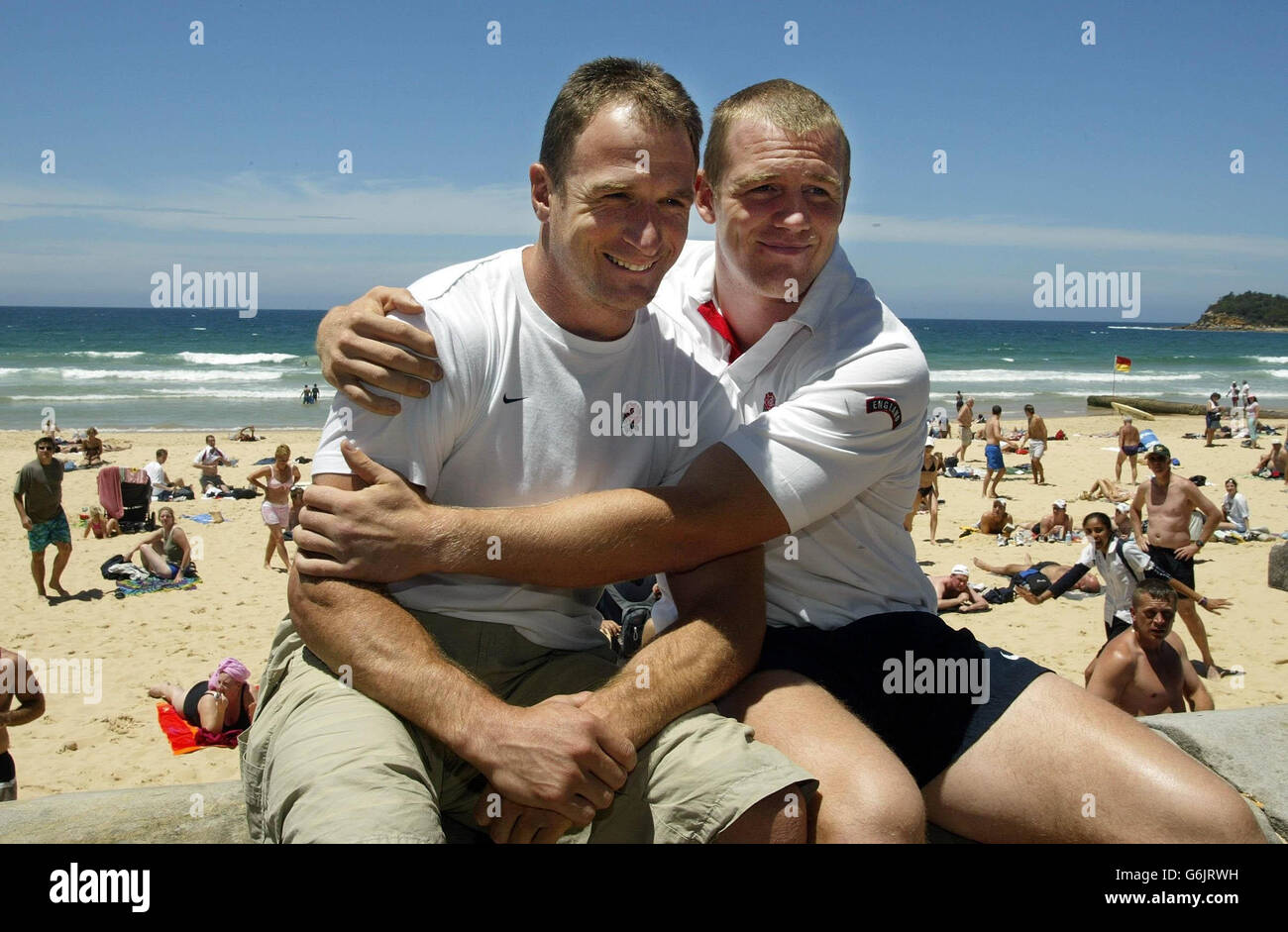 No mobile phone use. Internet sites may only use one image every five minutes during the match. Mike Catt (left) and Mike Tindall sit on Manly Beach, Sydney, after Tindall's selection above Catt's for England's team to face Australia in the Rugby World Cup Final on Saturday. Tough-tackling Tindall was omitted in favour of Catt for the semi-final victory over France, but the pair have now swapped places, with Catt, seven years his senior, on the bench. Stock Photo