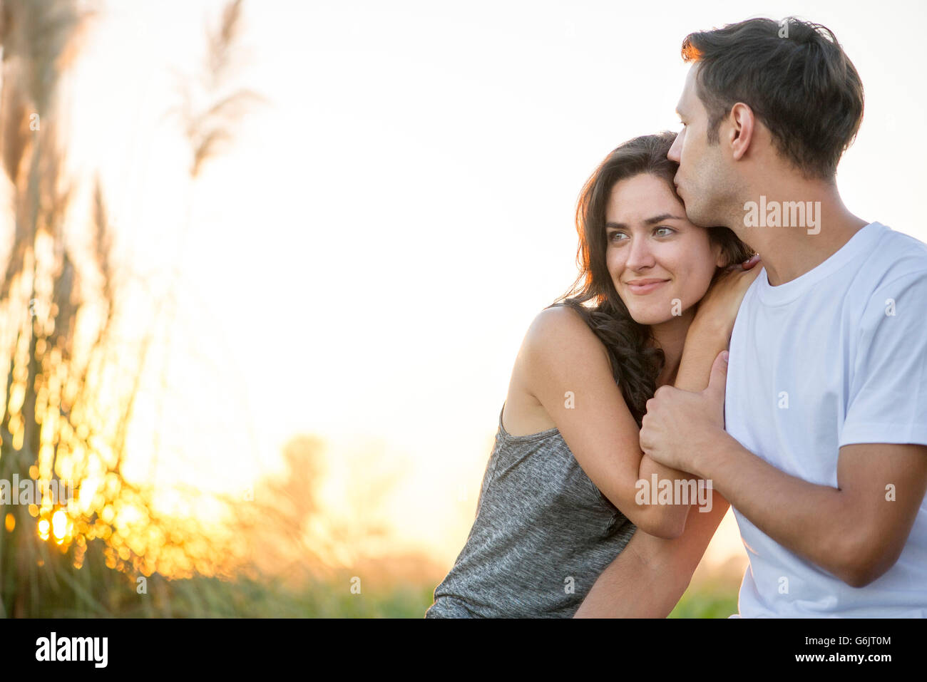 Man kissing girlfriend's forehead Stock Photo
