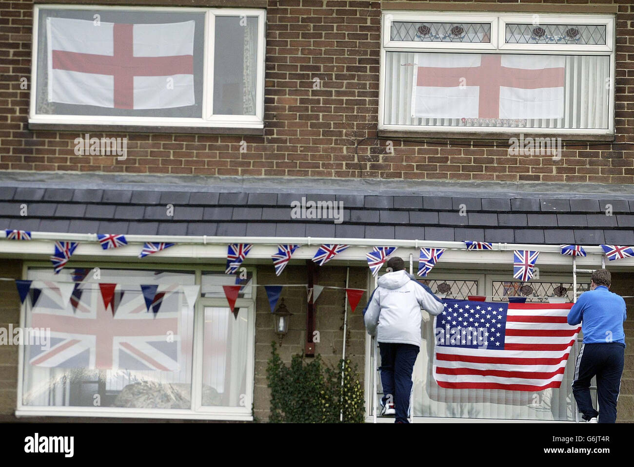 Residents in Trimdon put up flags next door to the home of former RAF serviceman and neighbour of Prime Minister Tony Blair, Owen Willoughby, 84 (house on the left) who has died, the day before he was invited to a historic pub lunch with the Prime Minister and US President George Bush in Sedgefield, County Durham. Owen Willoughby lived directly across from Mr Blair's constituency home, Myrobella House, and was due to have lunch with the President tomorrow, whilst on his State Visit to Britain. Stock Photo