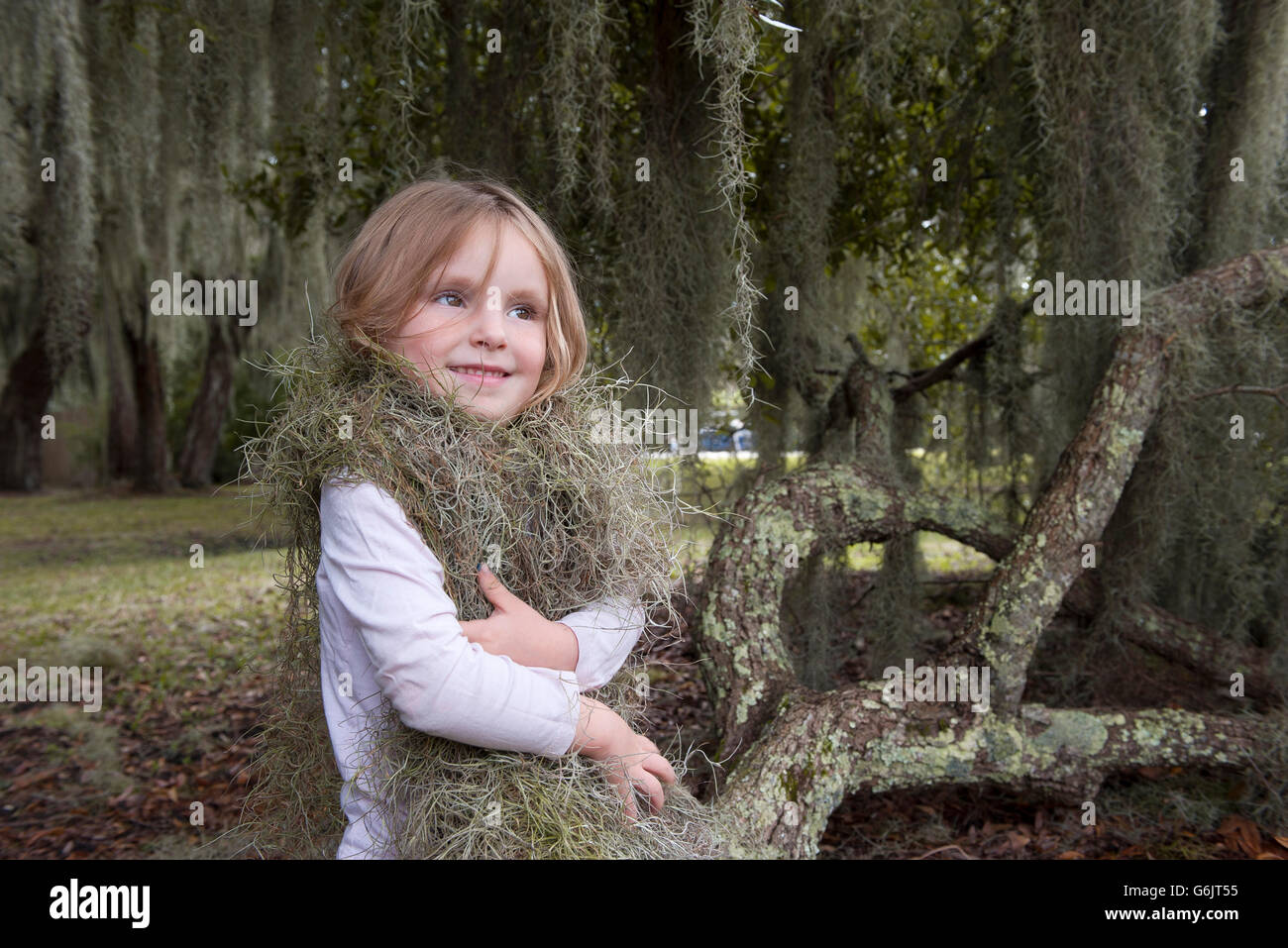 Little girl wrapped up in Spanish moss, Jekyll Island, Georgia, USA Stock Photo