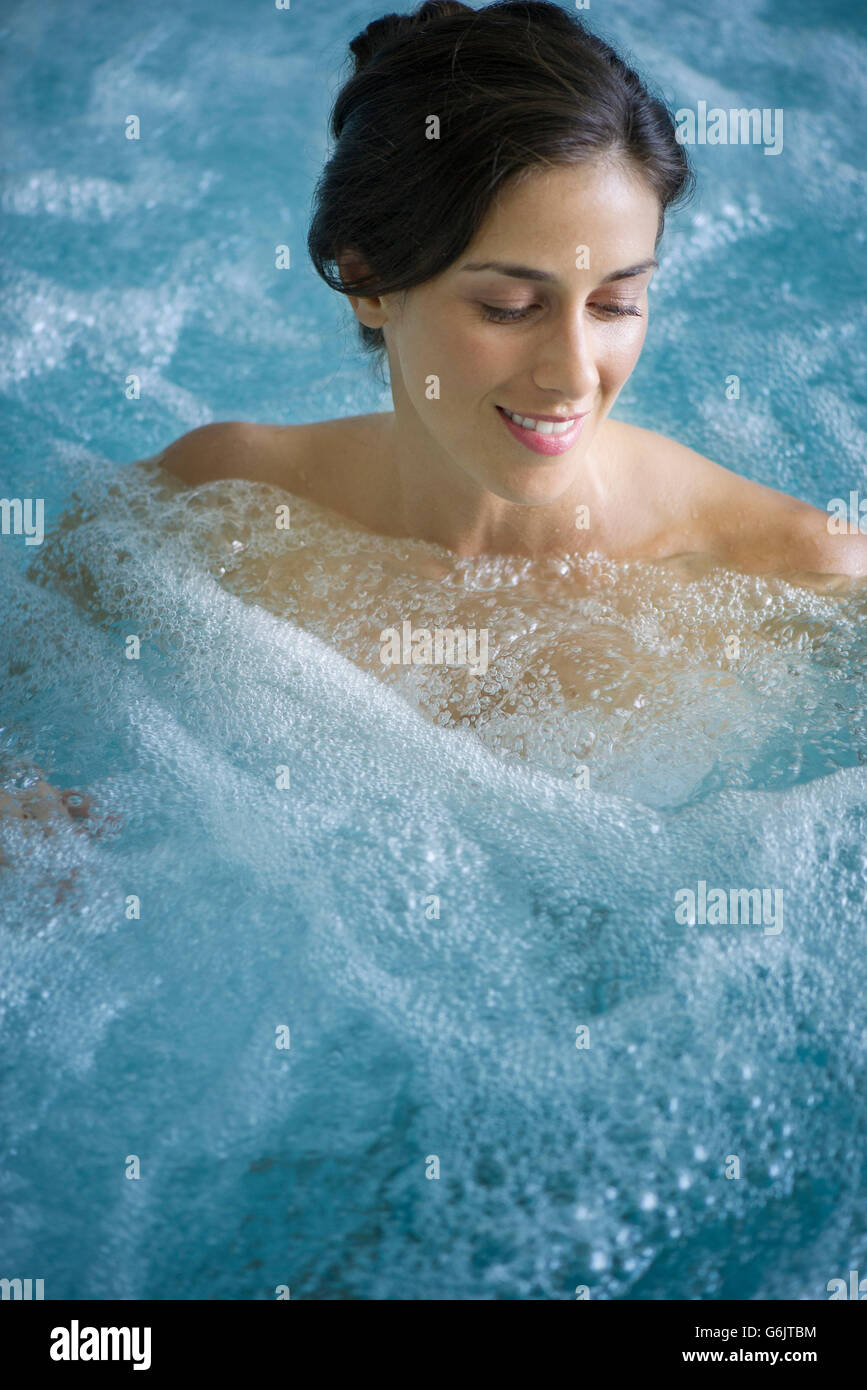 Woman In Jacuzzi Woman relaxing in jacuzzi Stock Photo - Alamy