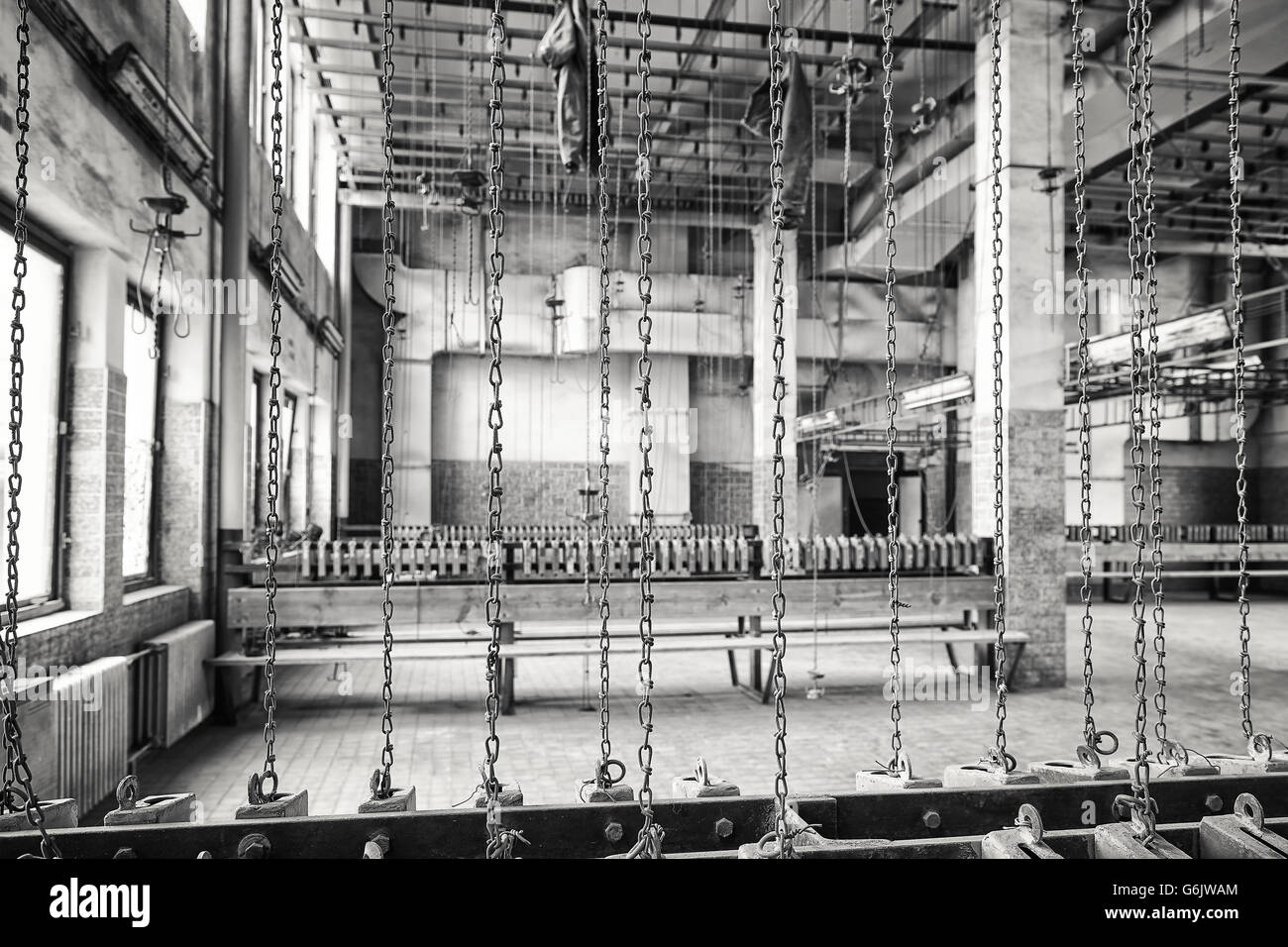 Black and white photo of rusty chains in old abandoned coal mine, focus on chains. Stock Photo