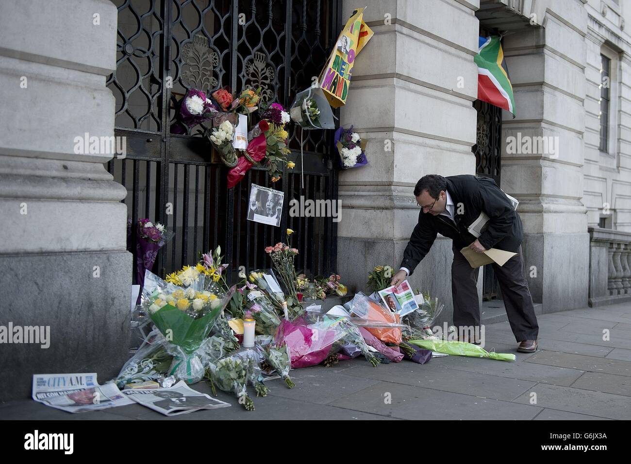 RETRANSMITTED CORRECTING CAPTION Floral tributes outside South Africa House, Trafalgar Square, central London following the announcement of the death of the former South African leader Nelson Mandela who has died at the age of 95. Stock Photo