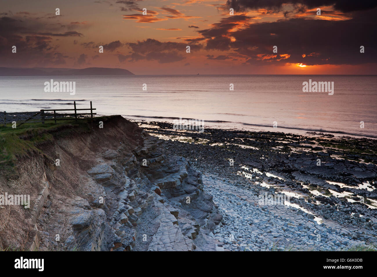 Sunset on a cloudy and showery evening at Kilve Beach, from the cliffs looking out over the Bristol Channel, United Kingdom Stock Photo