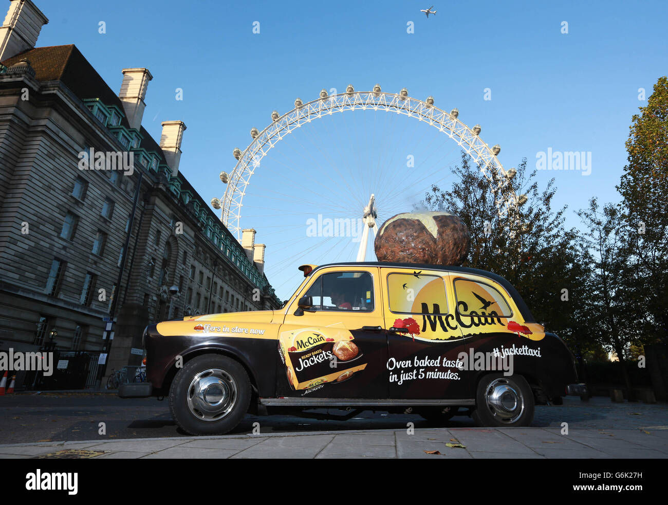 The McCain Ready Baked Jacket Taxi, a specially modified taxi with built in potato cooking facilities, parked in front of the London Eye in London. Stock Photo