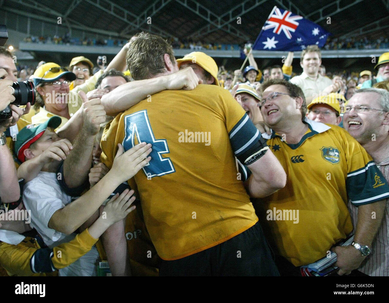 Australia's Justin Harrison celebrates with the crowd after their 22-10 victory over New Zealand in the Rugby World Cup semi-final match at the Telstra Stadium, Sydney. Australia went on to win the match 22-10. NO MOBILE PHONE USE. INTERNET SITES MAY ONLY USE ONE IMAGE EVERY FIVE MINUTES DURING THE MATCH Stock Photo