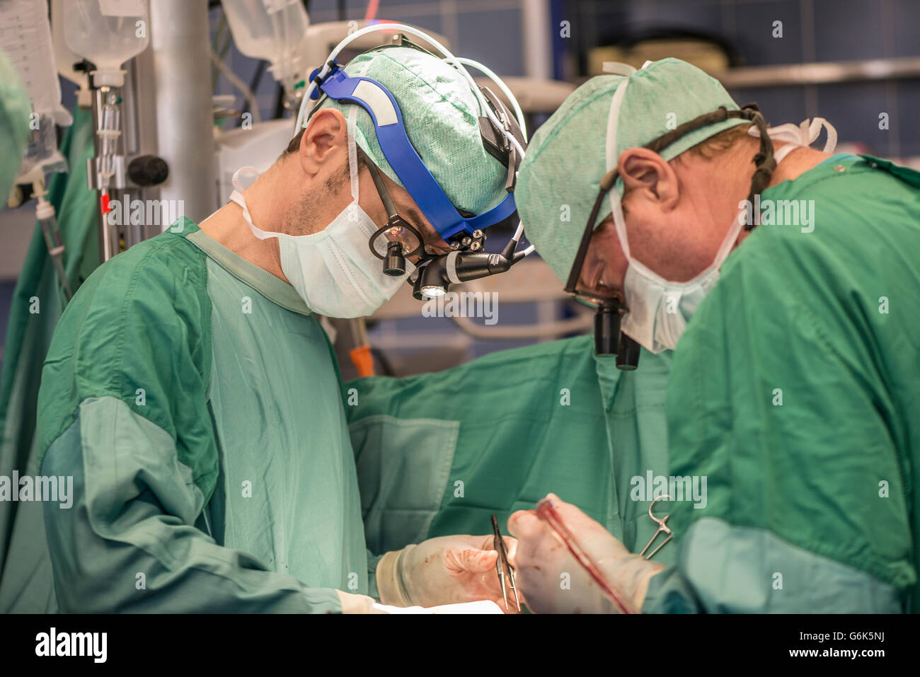 Surgeons executing heart bypass surgery Stock Photo