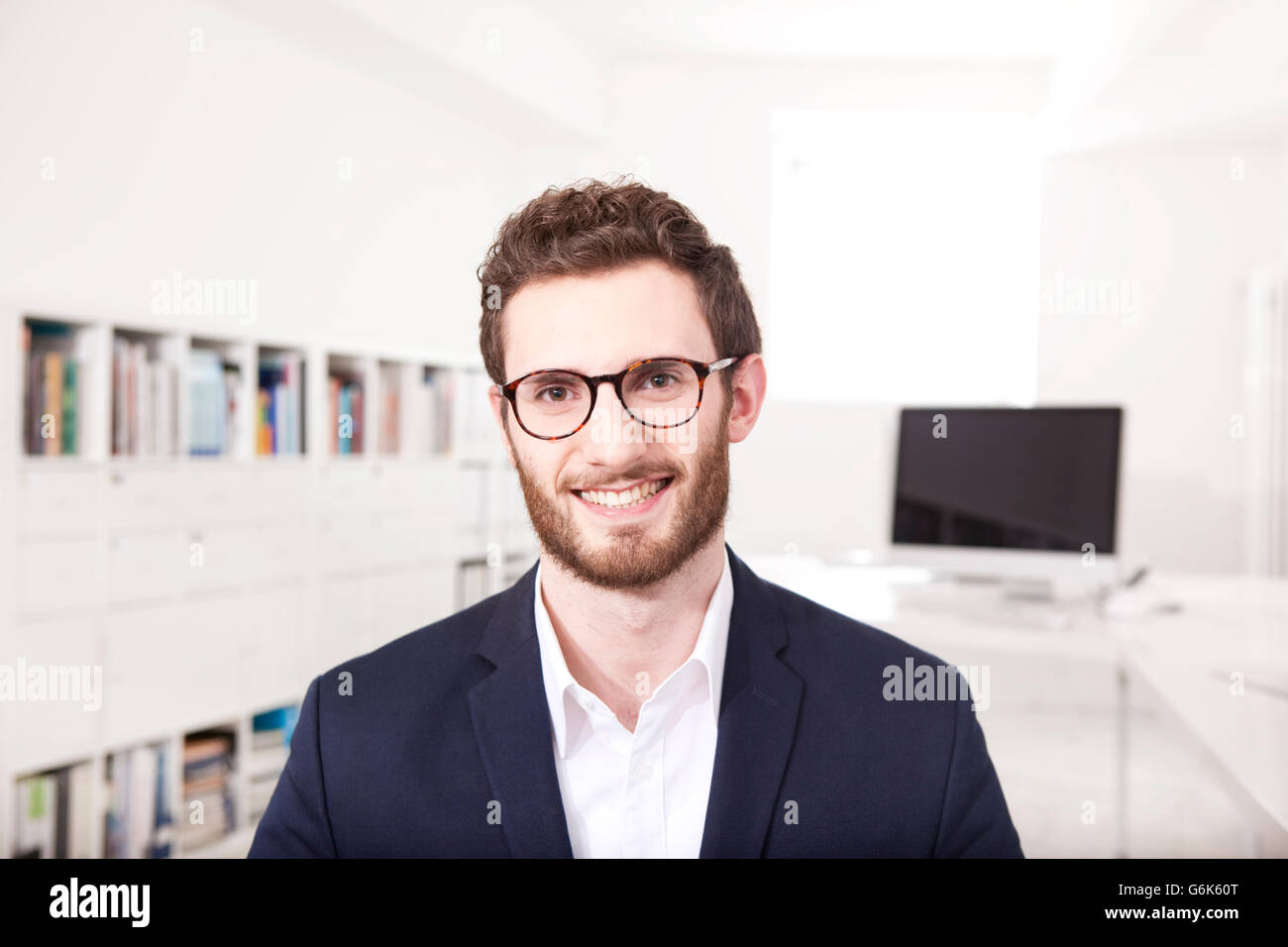 Portrait of smiling businessman in the office Stock Photo - Alamy