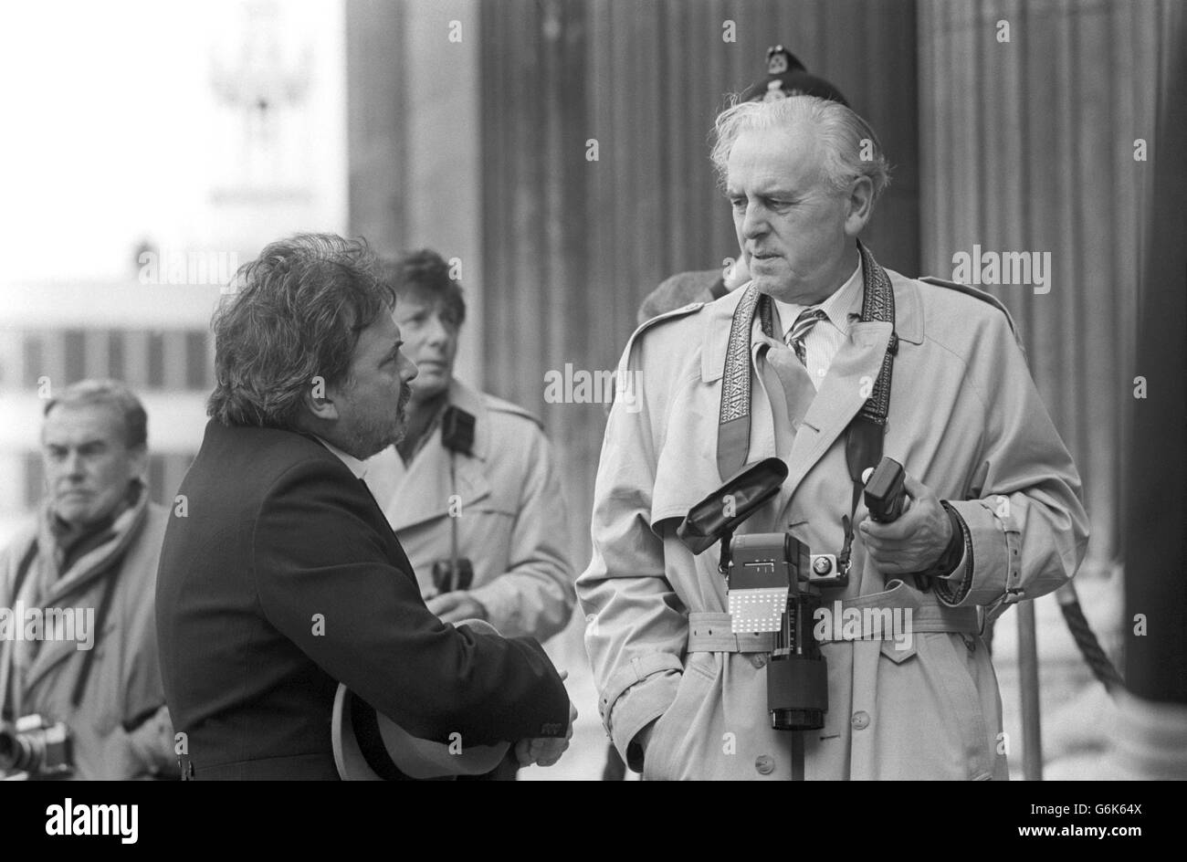 Actor George Cole plays the bungling photographer at a society wedding during filming on the steps of St Paul's Cathedral in London for another Olympus camera television commercial. Stock Photo