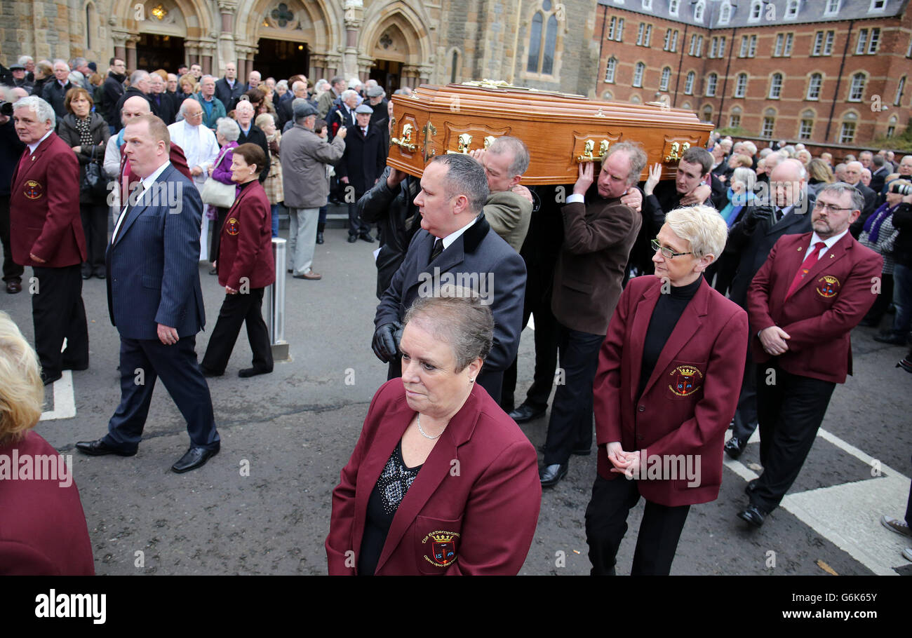 The coffin of Father Alex Reid is carried after the service at Clonard ...