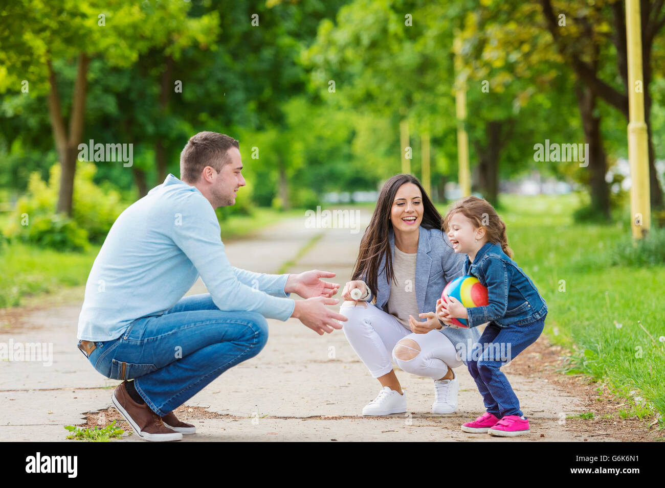 Happy family playing in park Stock Photo - Alamy