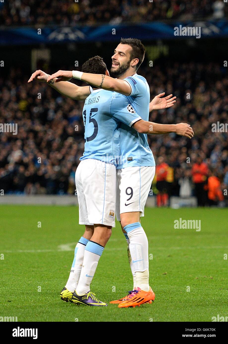 Manchester City's Alvaro Negredo (right) celebrates with his team-mate Gonzalez Jesus Navas (left) after scoring his team's third goal Stock Photo