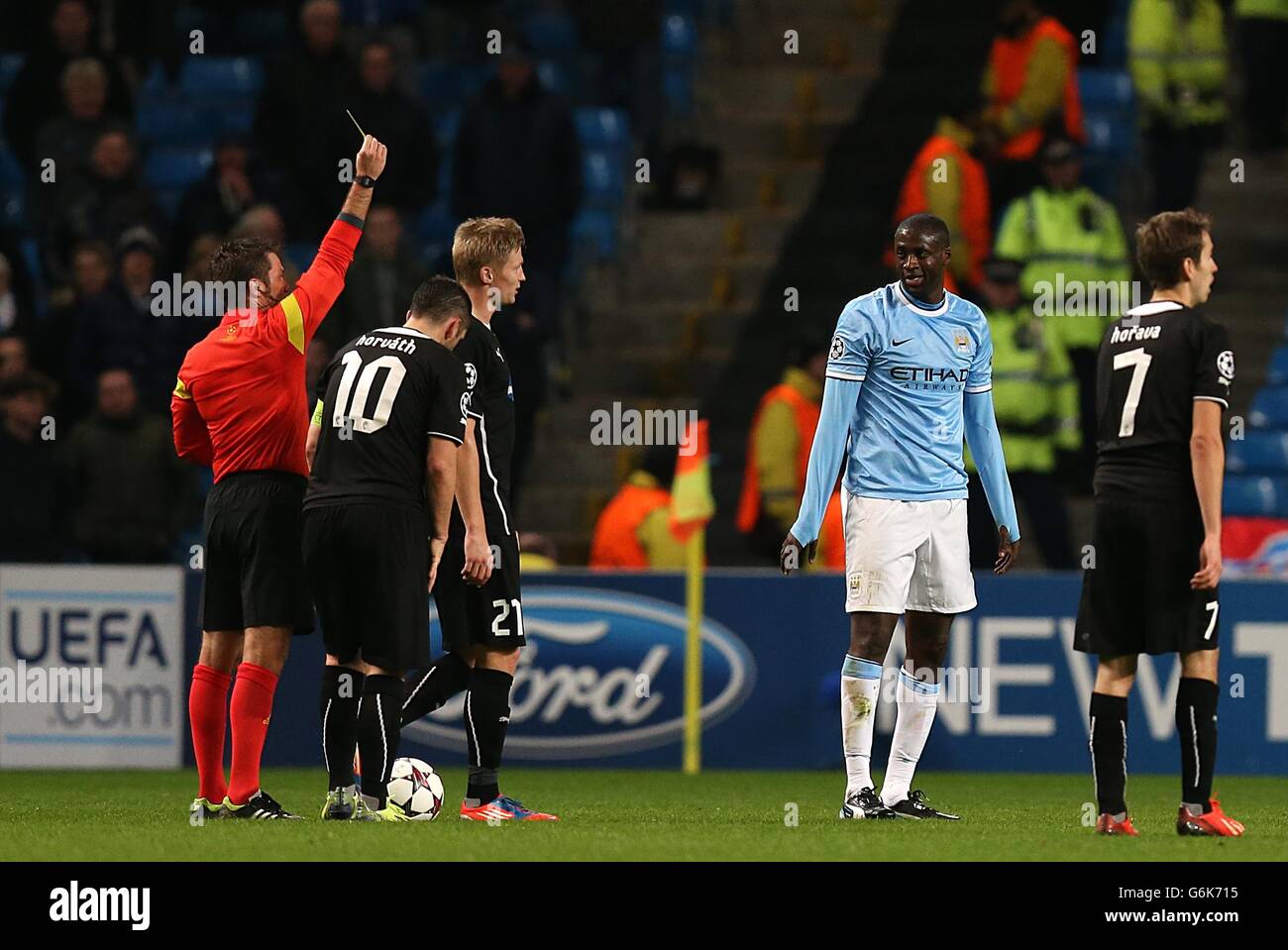 Manchester City's Yaya Toure (right) is shown the yellow card by referee Firat Aydinus meaning he is suspended for the next match Stock Photo