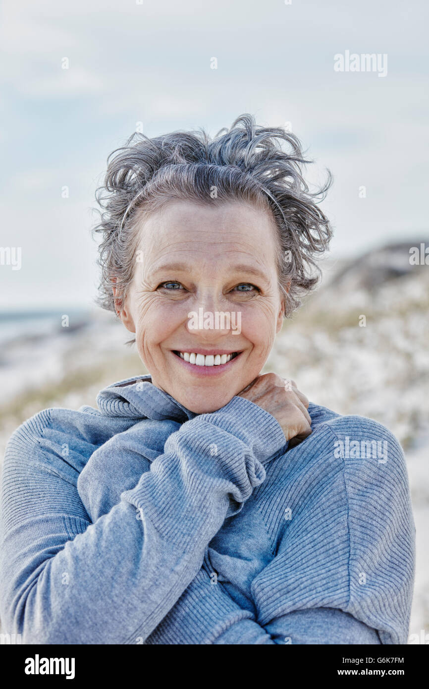 Portrait of smiling woman on the beach Stock Photo - Alamy