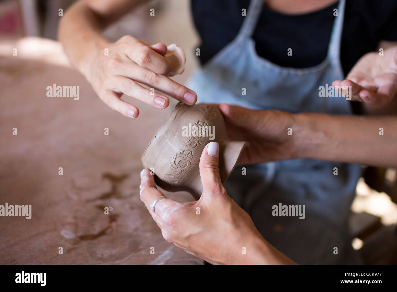 Man and woman in workshop working on pottery Stock Photo - Alamy