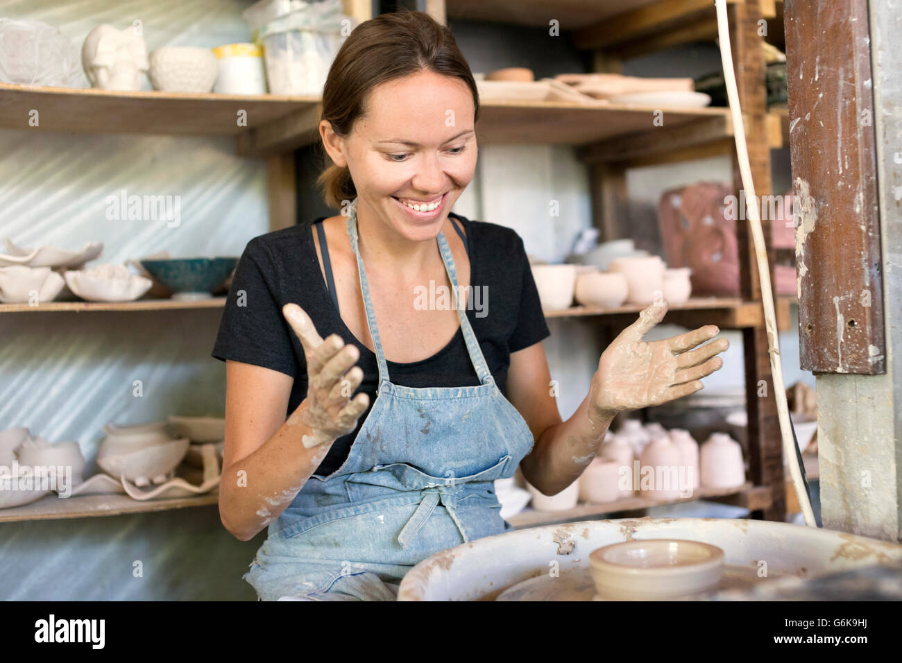 Smiling woman working in pottery Stock Photo - Alamy