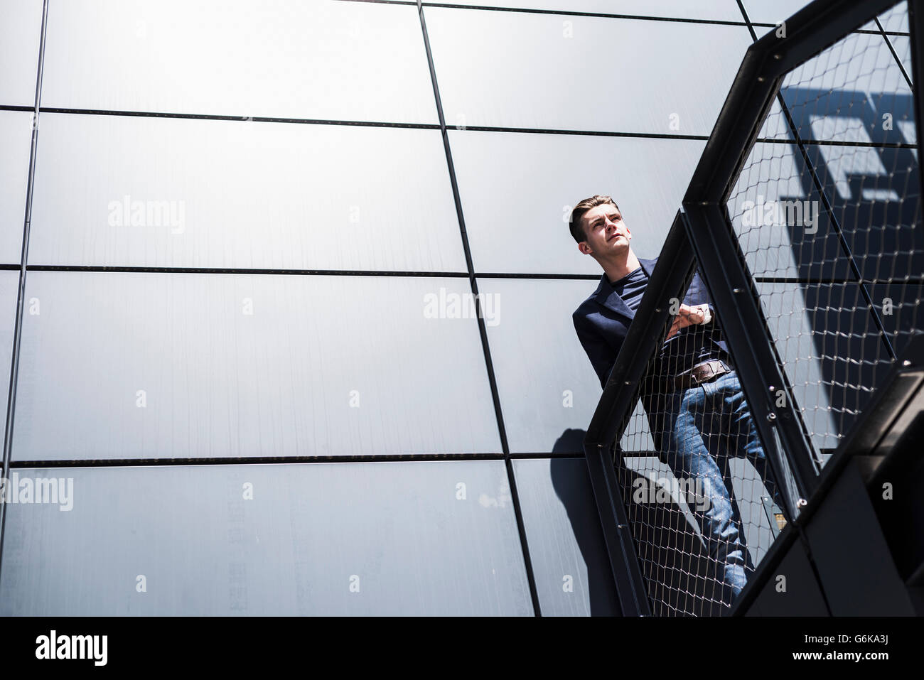 Man With Building Confident young man in front of building Stock Photo - Alamy