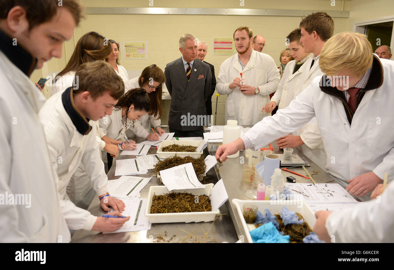 The Prince of Wales talks to students learning about silage during a visit to the Royal Agricultural University's Rural Innovation Centre at Manor Farm in Gloucestershire. Stock Photo