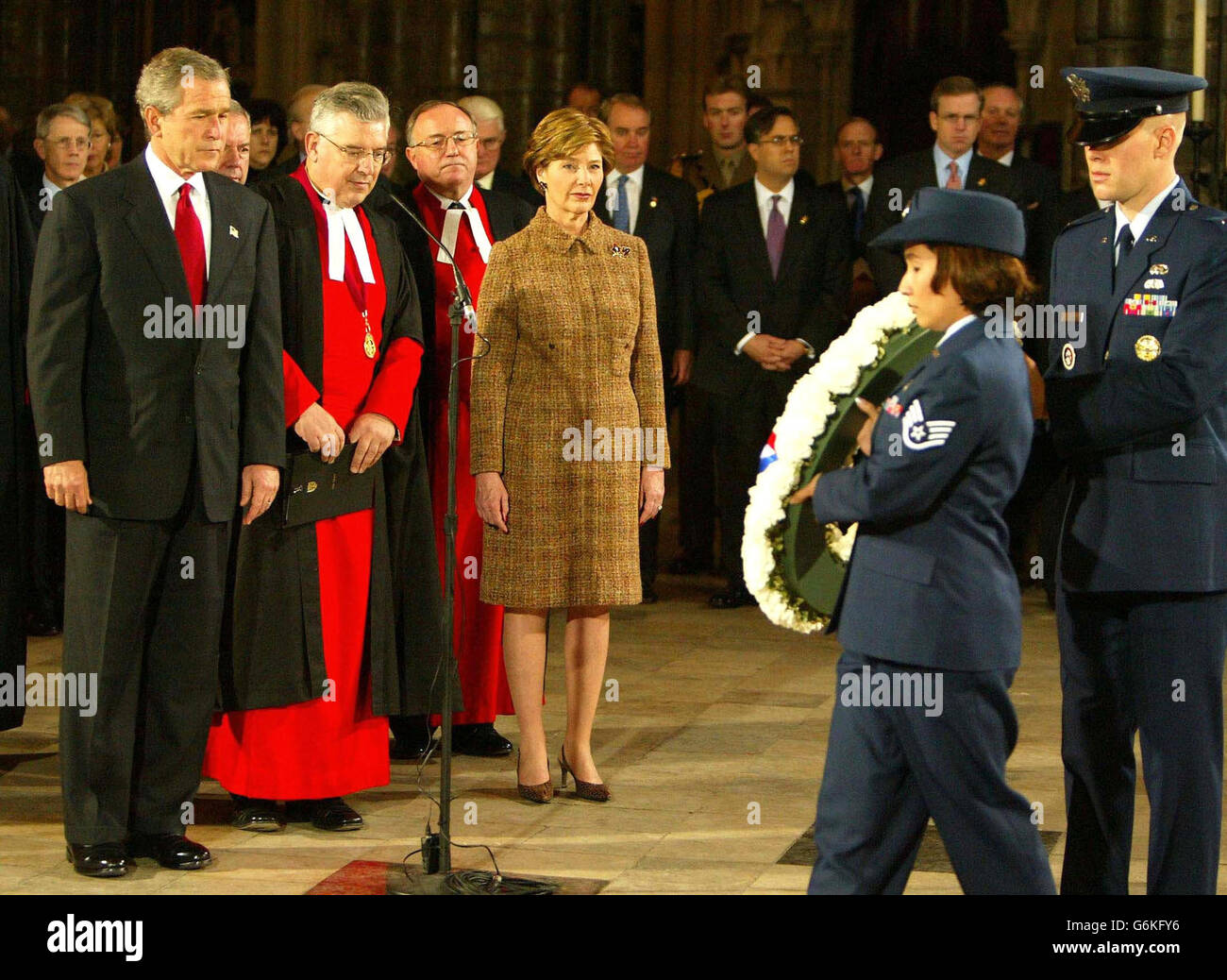 US President George Bush and his wife, Laura, watch during a service inside Westminster Abbey in central London as American service personnel lay a wreath at the Tomb of the Unknown Soldier at the start of the second day of his State Visit. The President and his wife are staying at Buckingham Palace throughout their visit as guests of Britain's Queen Elizabeth II. Stock Photo