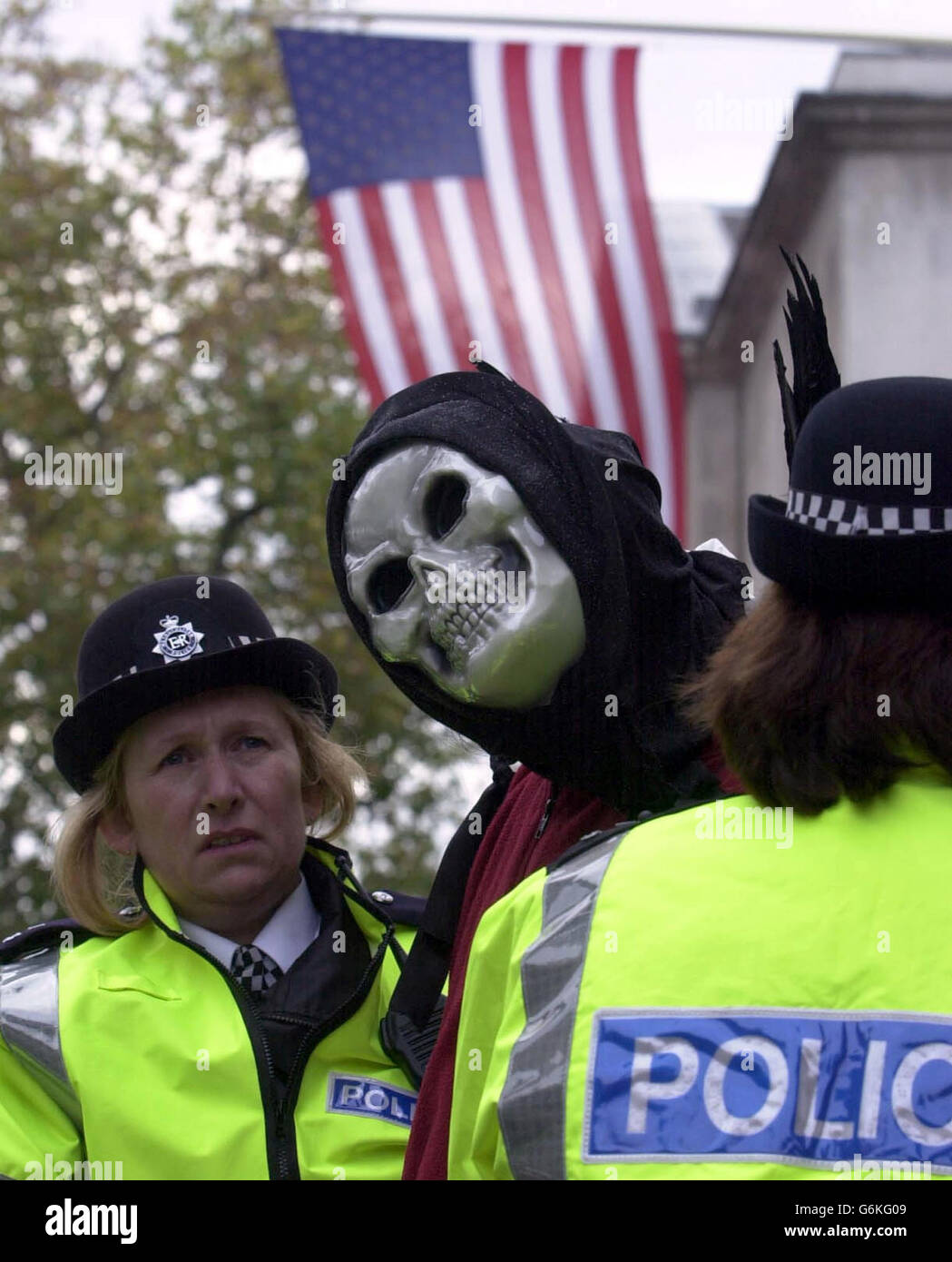 A demonstrator is led away by officers in London's Whitehall, as police await a mass protest against the state visit by US President George W Bush. Tens of thousands were expected on the capital's streets in what organisers hoped would be Britain's largest weekday protest. Stock Photo