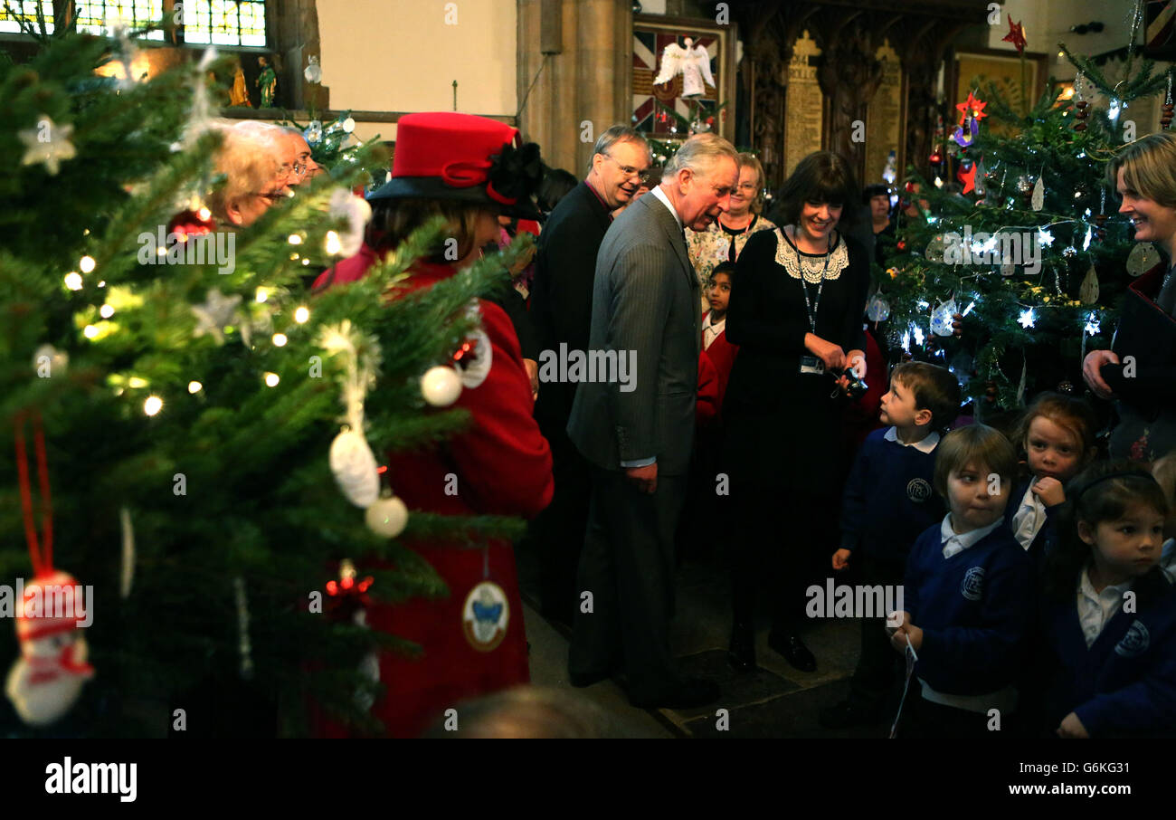 The Prince of Wales looks at Christmas trees during a visit to the