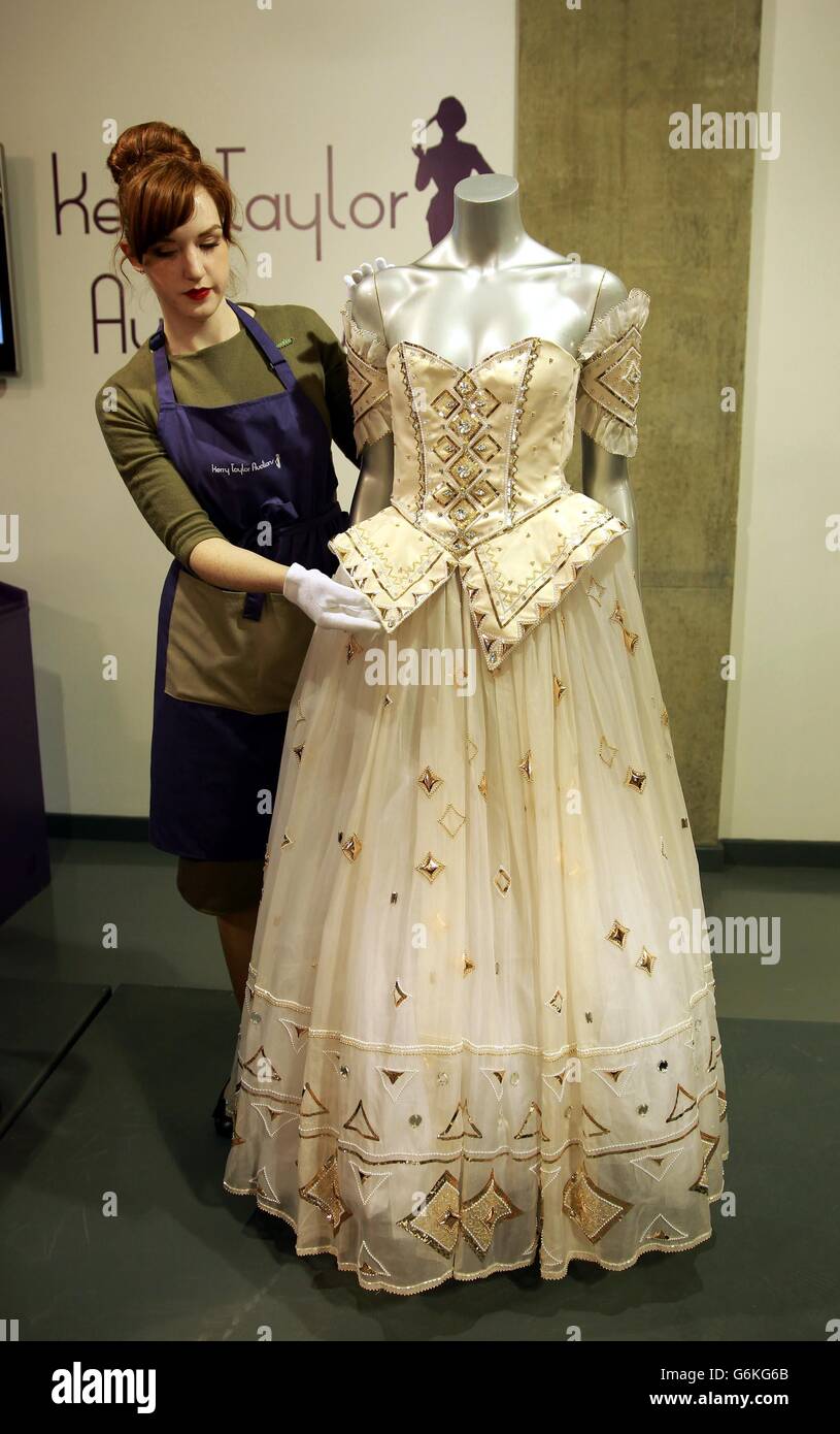 The ornate gown, designed by David and Elizabeth Emanuel, worn by the Princess of Wales in 1986 is deadied for sale at Kerry Taylor Auctions in south London. Stock Photo